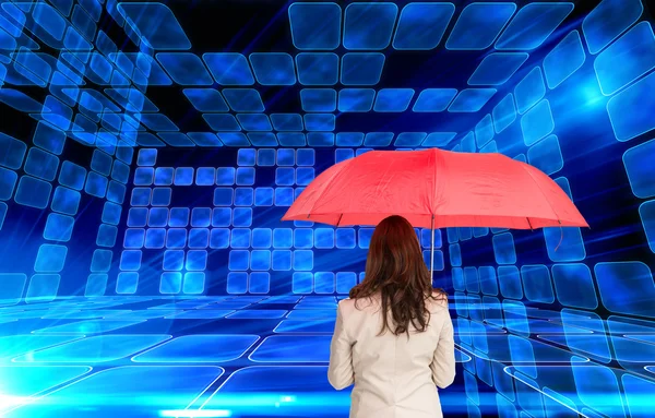 Composite image of businesswoman standing back to camera holding — Stock Photo, Image