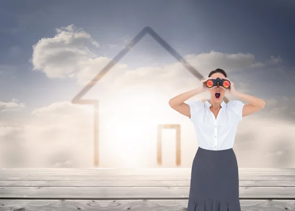 Elegant businesswoman looking through binoculars — Stock Photo, Image