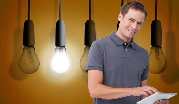 Smiling young man with tablet computer — Stock Photo, Image