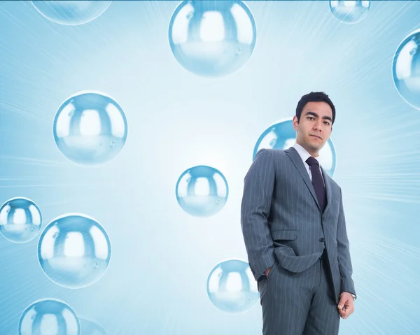 Composite image of unsmiling businessman standing — Stock Photo, Image