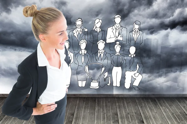 Composite image of businesswoman standing with hands on hips — Stock Photo, Image