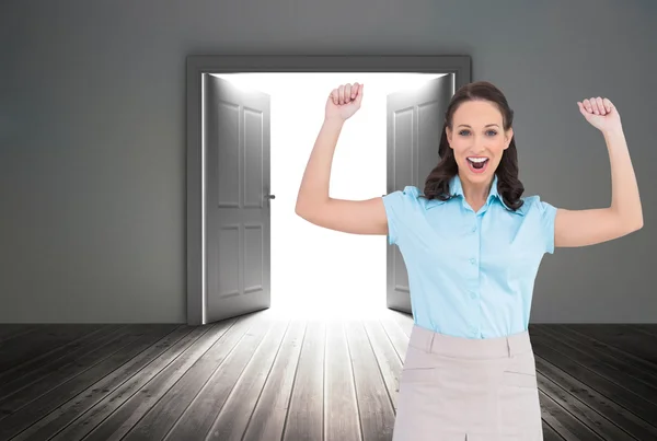 Composite image of victorious stylish businesswoman posing — Stock Photo, Image