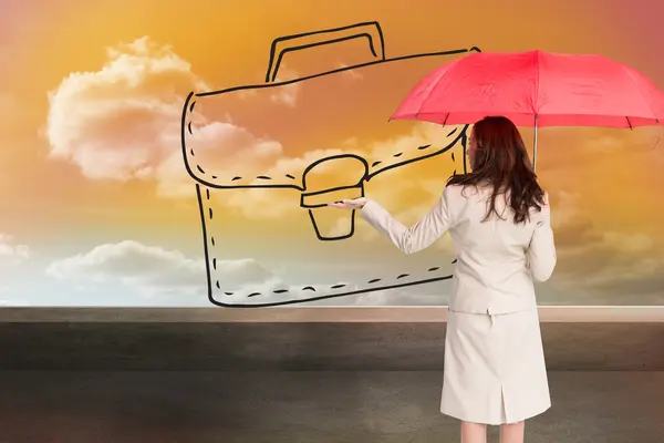 Composite image of businesswoman holding umbrella — Stock Photo, Image