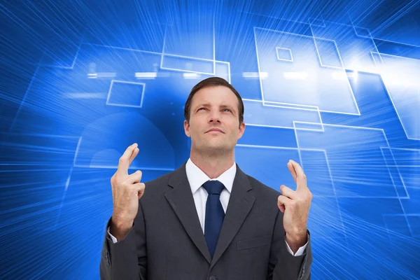 Businessman with fingers crossed is looking up — Stock Photo, Image