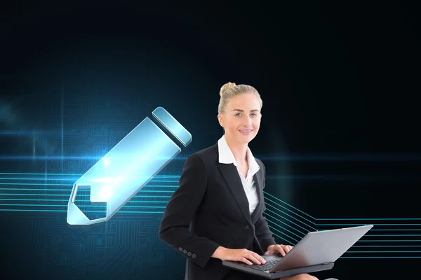 Composite image of businesswoman using laptop — Stock Photo, Image