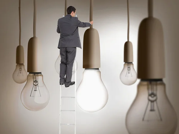 Composite image of businessman standing on ladder — Stock Photo, Image