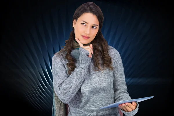 Model wearing winter clothes holding her tablet — Stock Photo, Image