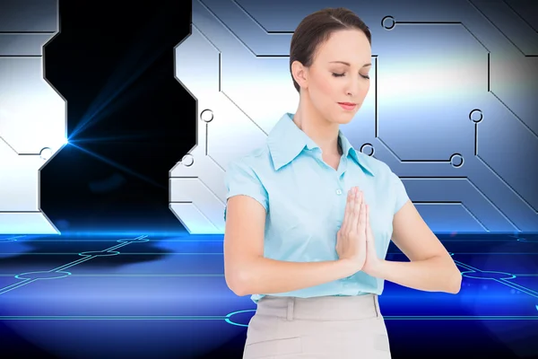 Peaceful young businesswoman praying — Stock Photo, Image