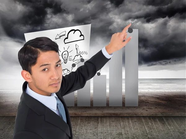 Composite image of unsmiling asian businessman pointing — Stock Photo, Image