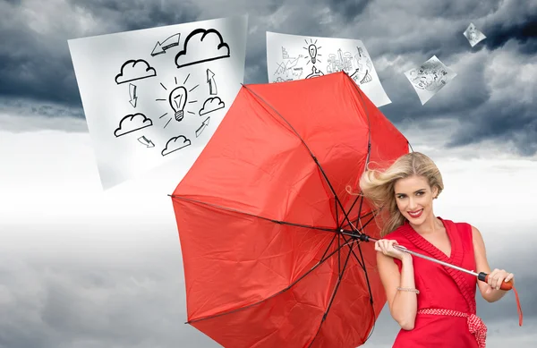 Image composite d'une blonde souriante tenant un parapluie — Photo