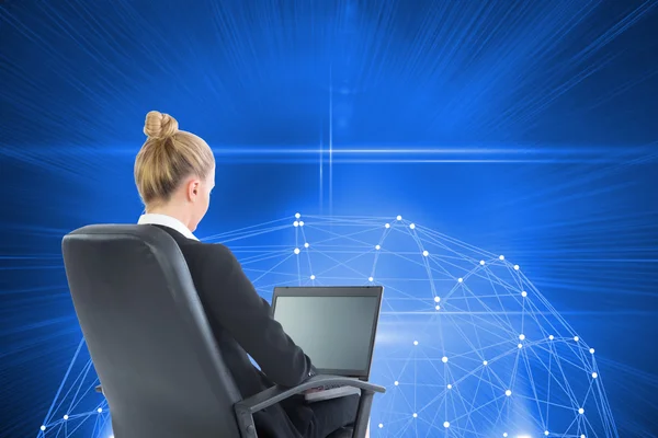 Composite image of businesswoman sitting on swivel chair with laptop — Stock Photo, Image