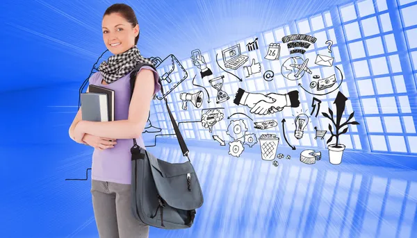 Student holding books and her bag while standing — Stock Photo, Image