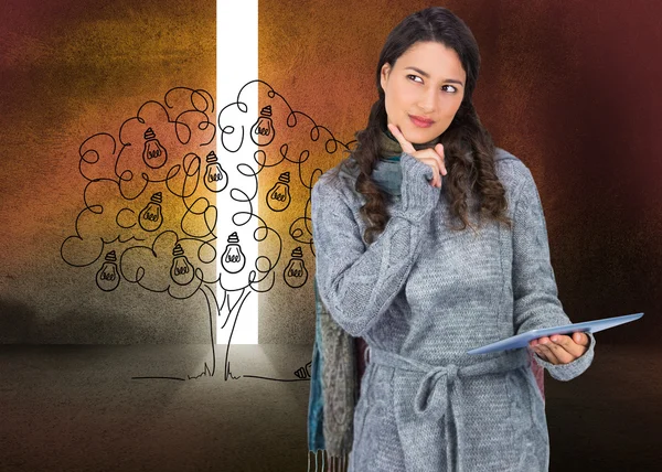 Composite image of pensive model wearing winter clothes holding — Stock Photo, Image