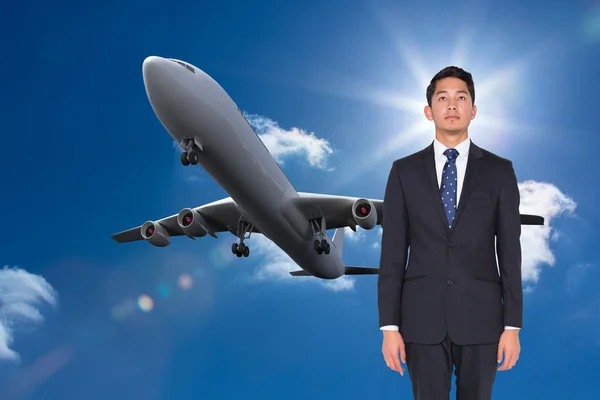 Composite image of serious businessman looking up — Stock Photo, Image