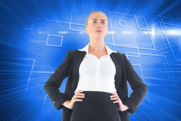 Composite image of businesswoman standing with hands on hips — Stock Photo, Image