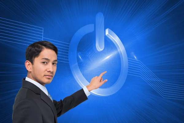 Composite image of stern asian businessman pointing — Stock Photo, Image