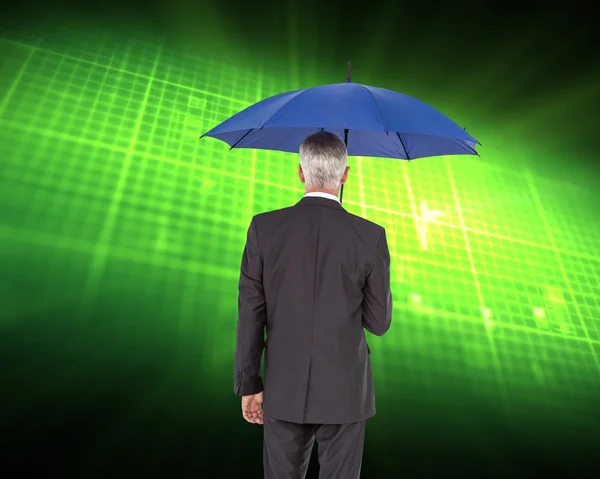 Composite image of businessman holding umbrella — Stock Photo, Image