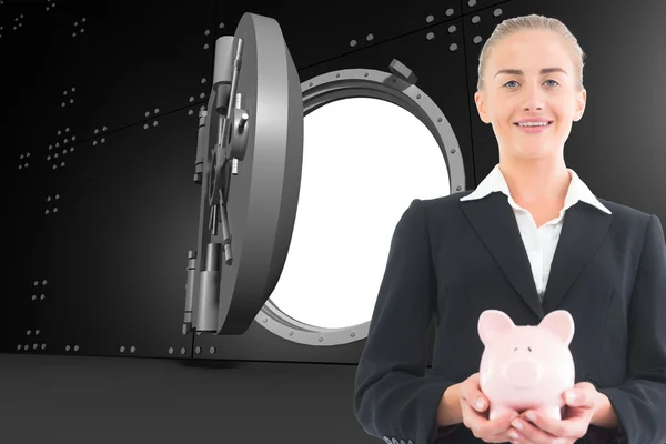 Složený obraz podnikatelka drží prasátko — Stock fotografie