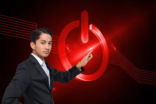 Composite image of unsmiling asian businessman pointing — Stock Photo, Image