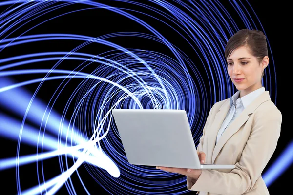 Confident businesswoman holding laptop — Stock Photo, Image