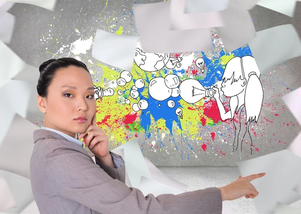 Composite image of thoughtful asian businesswoman pointing — Stock Photo, Image