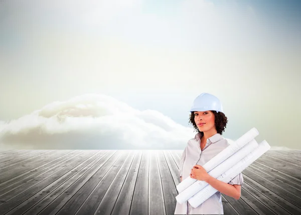 Confident woman holding construction plans — Stock Photo, Image