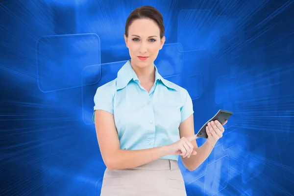 Composite image of serious classy businesswoman using calculator — Stock Photo, Image