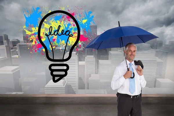 Businessman holding umbrella — Stock Photo, Image