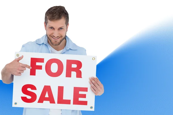 Model holding a for sale sign — Stock Photo, Image