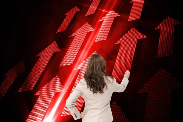 Composite image of businesswoman standing back to camera writing — Stock Photo, Image