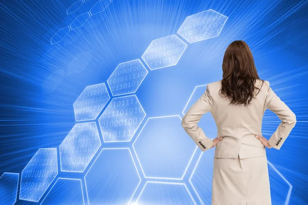 Composite image of businesswoman standing back to camera — Stock Photo, Image