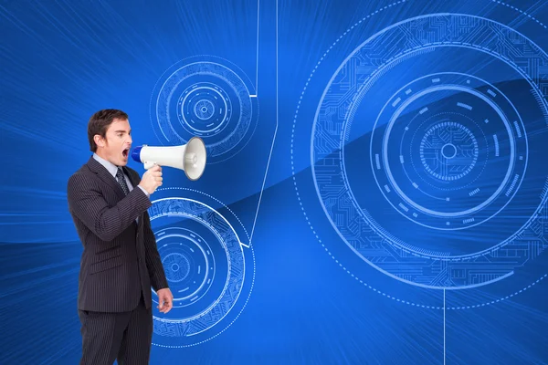 Businessman shouting through a megaphone — Stock Photo, Image