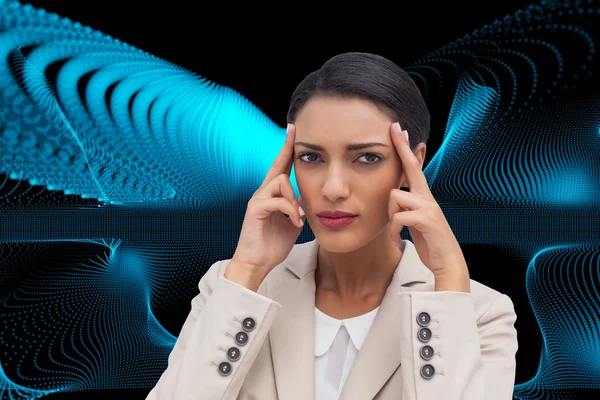 Composite image of young businesswoman putting her fingers on her temples — Stock Photo, Image