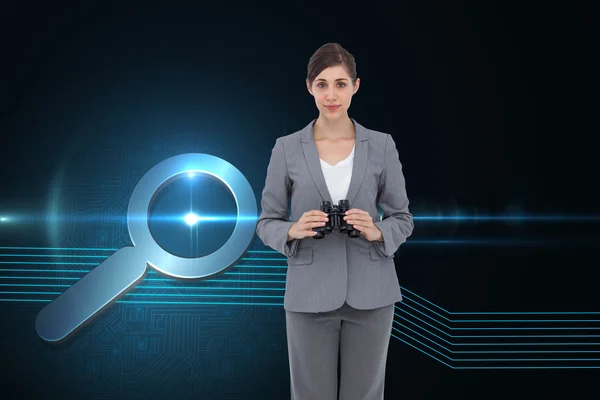 Composite image of young businesswoman with binoculars — Stock Photo, Image