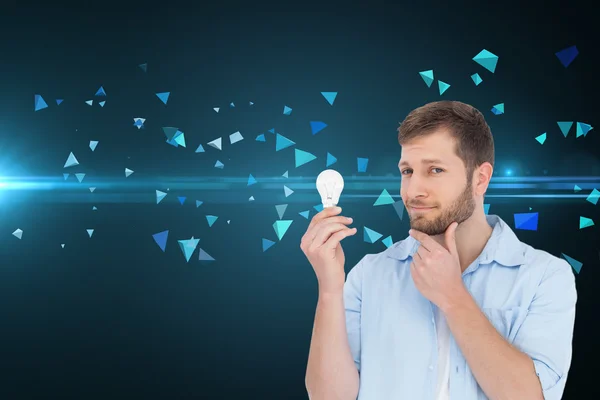 Handsome model holding a bulb — Stok fotoğraf