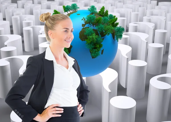 Composite image of businesswoman standing with hands on hips — Stock Photo, Image