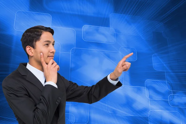 Composite image of thoughtful asian businessman pointing — Stock Photo, Image