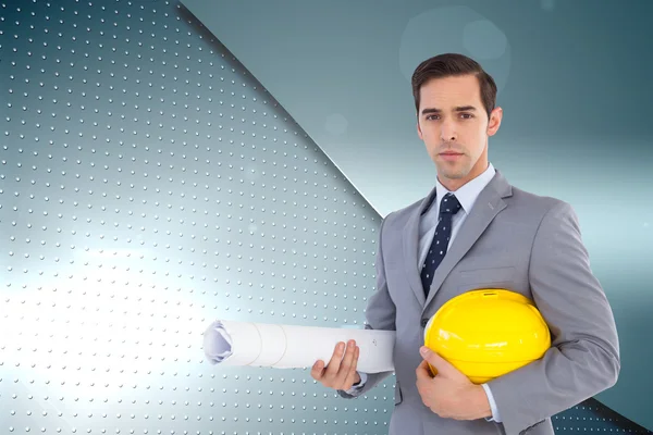 Serious architect holding plans and hard hat — Stock Photo, Image