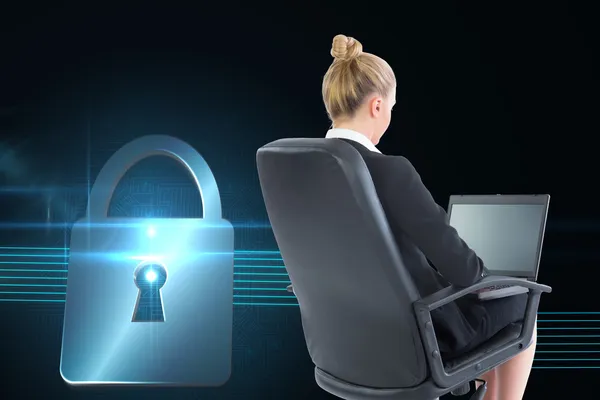 Composite image of businesswoman sitting on swivel chair with laptop — Stock Photo, Image