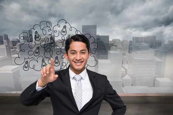 Composite image of smiling asian businessman pointing — Stock Photo, Image