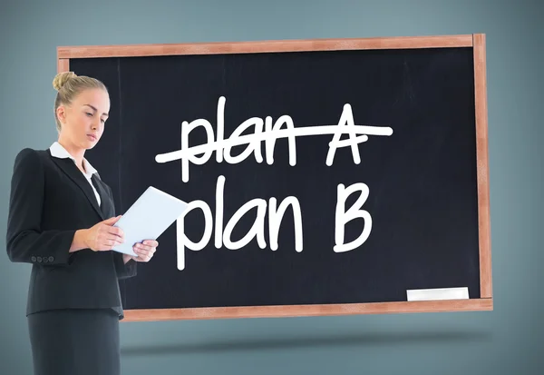 Composite image of businesswoman holding new tablet — Stock Photo, Image