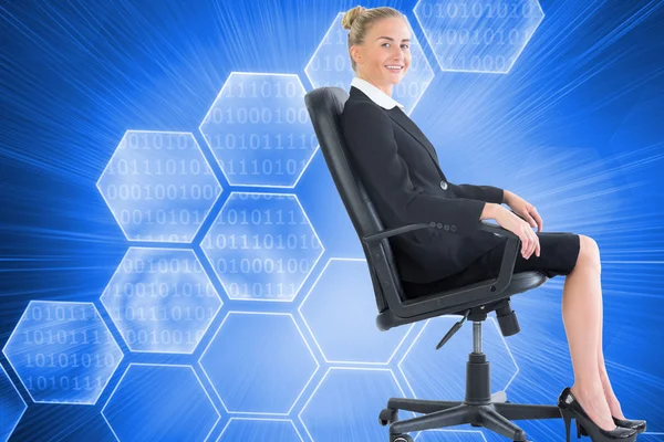 Composite image of businesswoman sitting in swivel chair — Stock Photo, Image