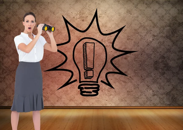 Astonished elegant businesswoman holding binoculars — Stock Photo, Image