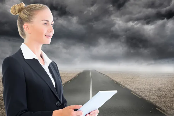 Composite image of businesswoman holding tablet — Stock Photo, Image