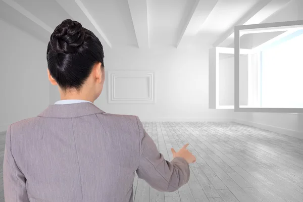 Composite image of asian businesswoman pointing — Stock Photo, Image