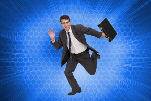 Composite image of cheerful businessman in a hury — Stock Photo, Image