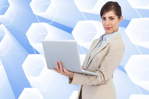 Confident young businesswoman with laptop — Stock Photo, Image