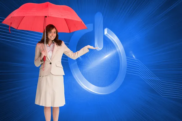 Brunette businesswoman holding umbrella — Stock Photo, Image