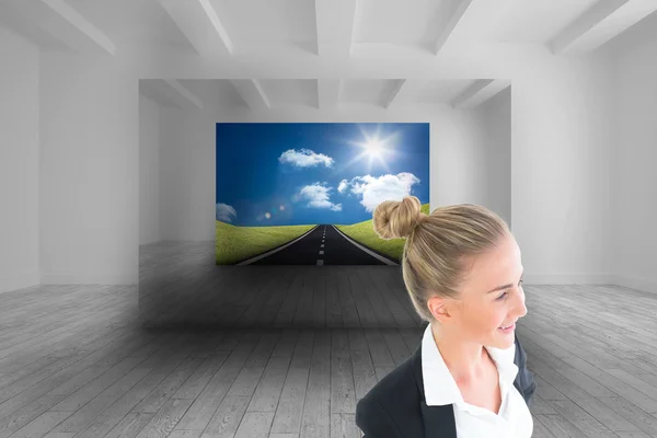 Composite image of businesswoman standing with hands on hips — Stock Photo, Image