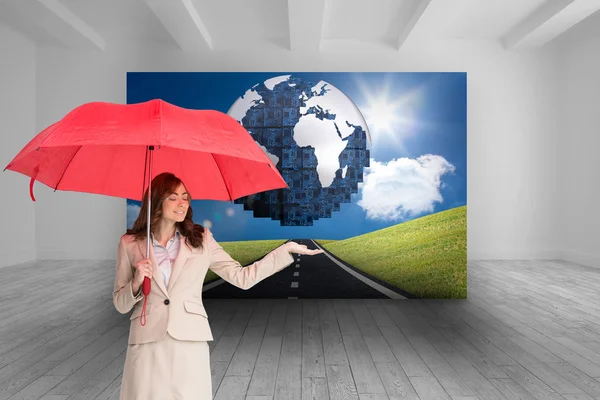 Composite image of attractive businesswoman holding red umbrella — Stock Photo, Image